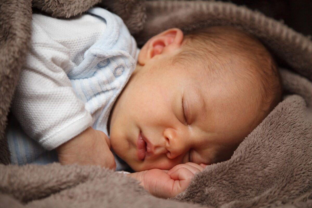 Baby sleep sack folded on a nursery chair